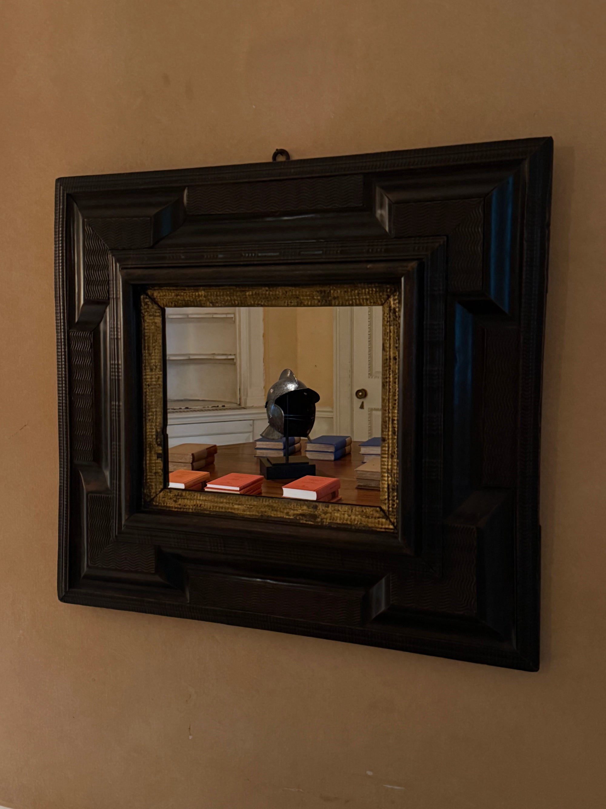 SMALL EBONIZED IN GILT FRAME MIRROR