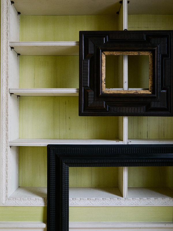 SMALL EBONIZED IN GILT FRAME MIRROR